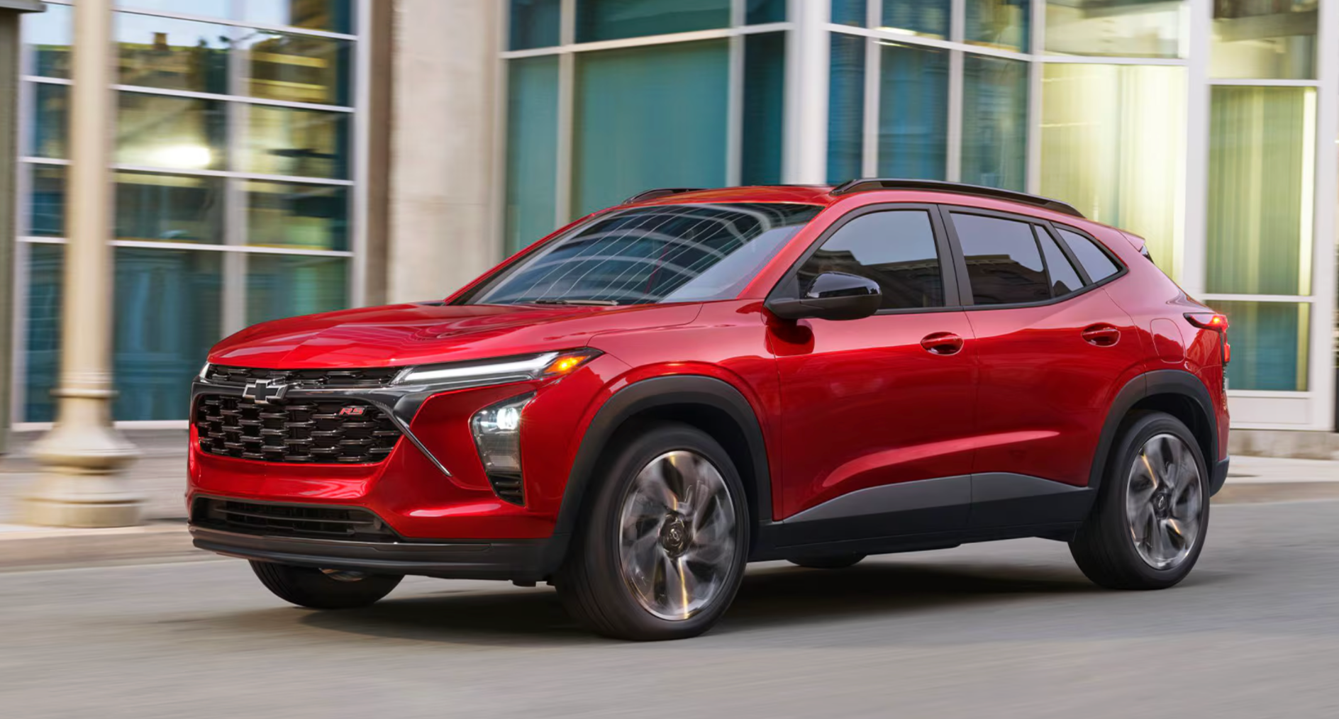 Red 2026 Chevy Trax driving in the city