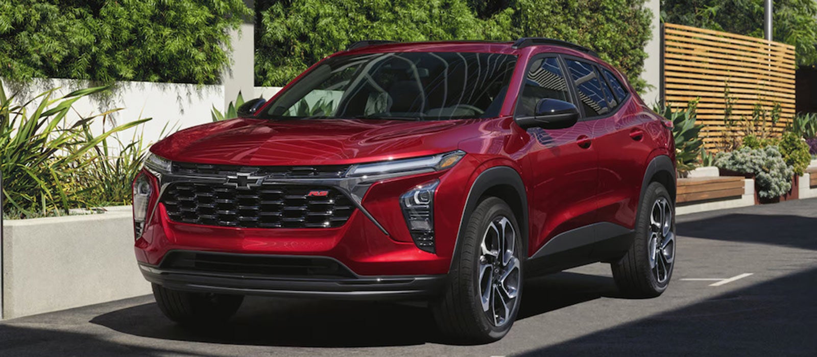 A side view of a red 2026 Chevrolet Trax SUV