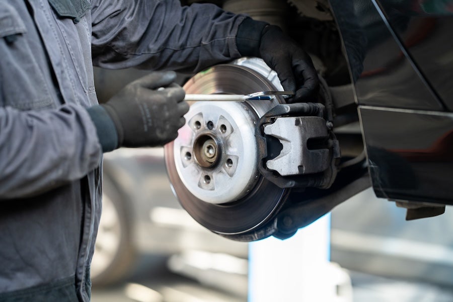 A technician working on a car’s brakes