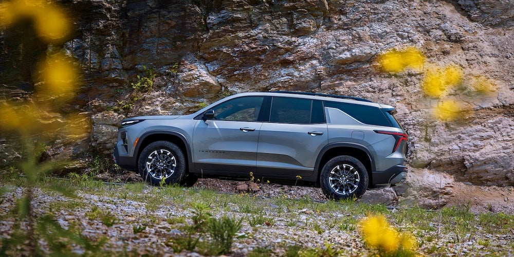 A gray 2026 Chevrolet Traverse SUV in a field